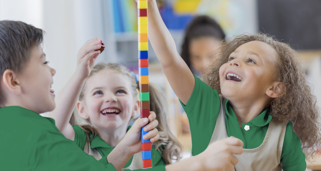 Diverse preschool friends play with counting cubes